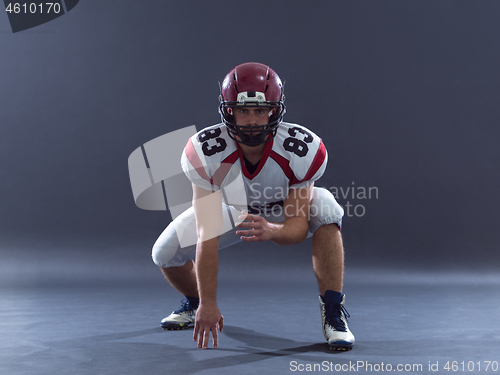 Image of American football player getting ready before starting