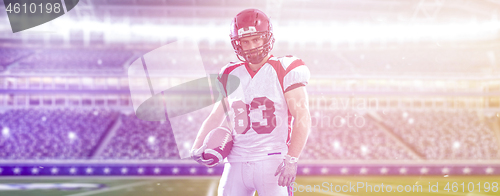 Image of American Football Player isolated on big modern stadium field