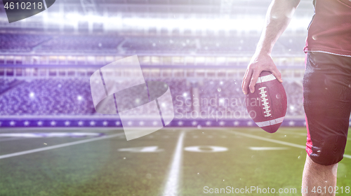 Image of closeup American Football Player isolated on big modern stadium