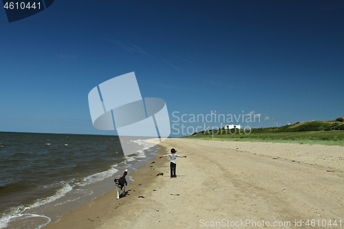 Image of The girl at the beach in the wind