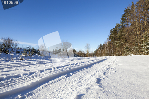 Image of plowed agricultural field covered by snow