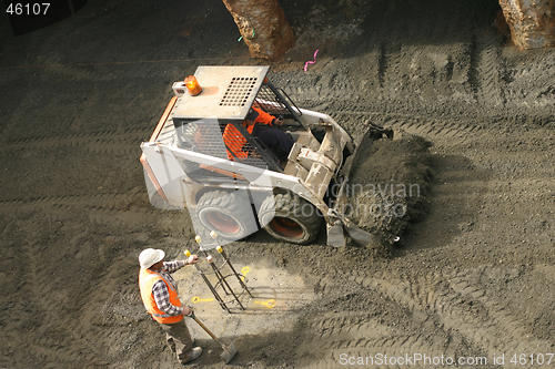 Image of Bobcat and construction worker