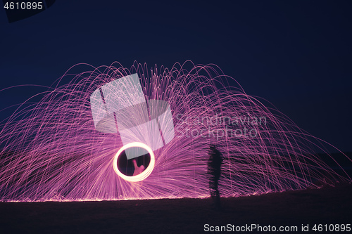 Image of steel wool firework with shadow of a man