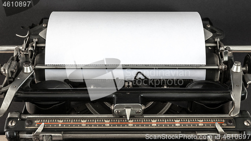 Image of Vintage typewriter with blank sheet of paper retro technology