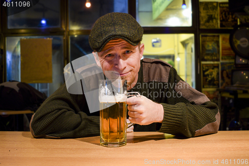 Image of Guy with beer in the bar