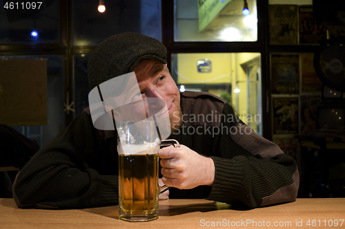 Image of Guy with beer in the bar