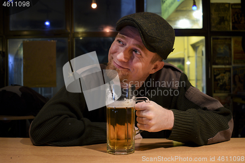 Image of Guy with beer in the bar