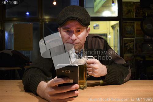 Image of Guy and phone in the bar