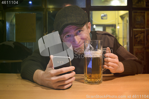 Image of Guy with beer in the bar