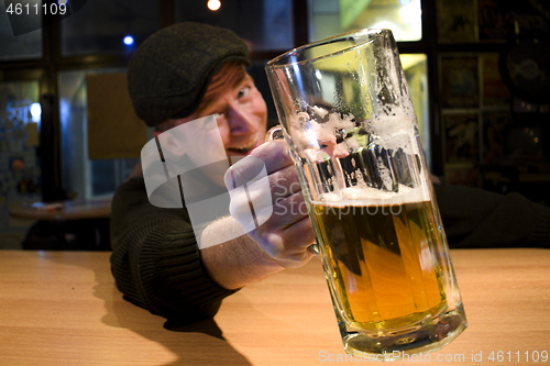 Image of Guy with beer in the bar