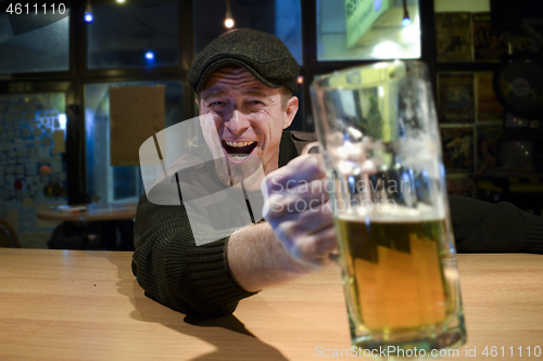 Image of Guy with beer in the bar