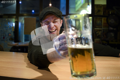 Image of Guy with beer in the bar