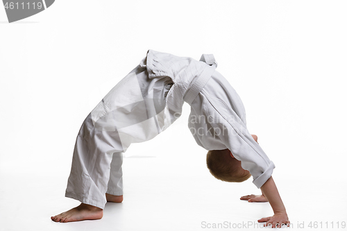 Image of Boy athlete makes a bridge at the warm-up of the judo section