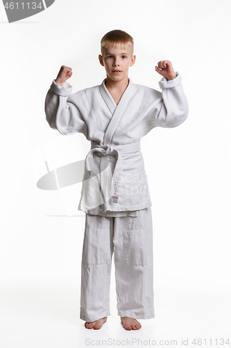 Image of Boy athlete is fond of judo and does warm-up hands