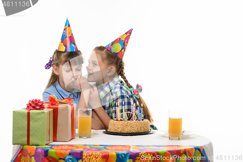 Image of Birthday girl tells secrets to another girl