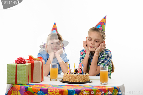 Image of Children at the holiday table are waiting for the holiday cake