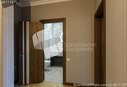 Image of Open door to the toilet, view from the corridor