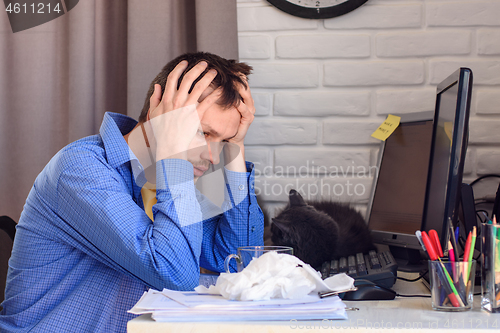 Image of Ill man looks at used handkerchiefs