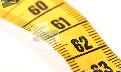 Image of Close-up of a yellow measuring tape isolated on white - 62