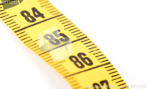 Image of Close-up of a yellow measuring tape isolated on white - 85