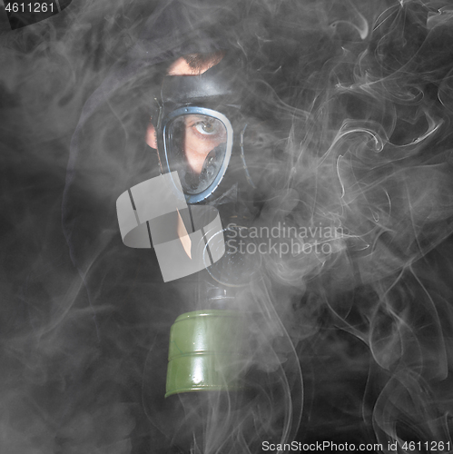 Image of Man in a gas mask in the smoke