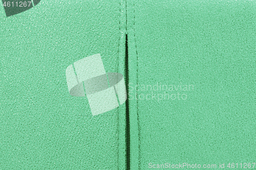 Image of Background from green suede close up, zipper in the middle