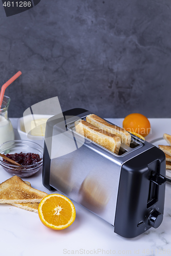 Image of Slices of toast coming out of the toaster for healthy breakfast