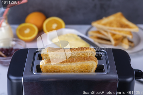 Image of Slices of toast coming out of the toaster for healthy breakfast