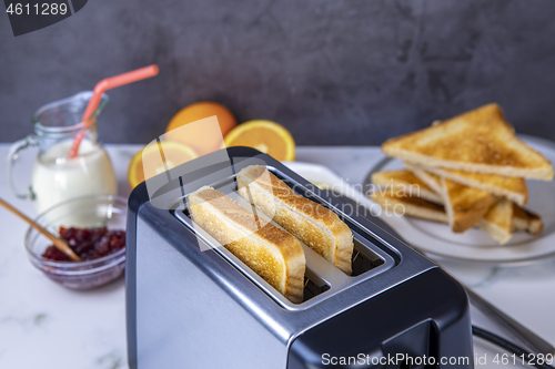 Image of Slices of toast coming out of the toaster for healthy breakfast