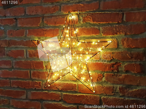 Image of Shining yellow star on a brick wall