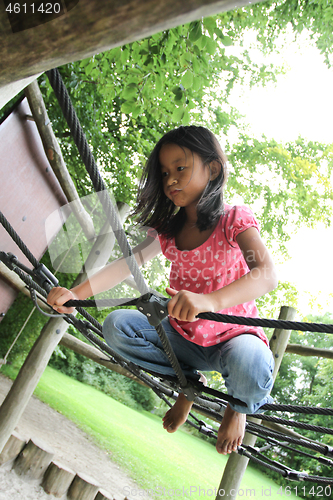 Image of Portrait of a young cute girl on a playing field