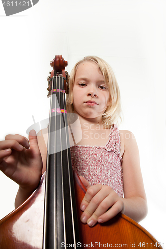 Image of Portrait of a young teenager girl in studio with a cello