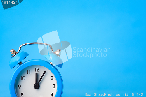 Image of Clock concept - time, right empty place, blue background