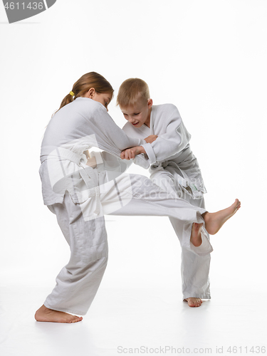 Image of Two judo students try to hook each other up