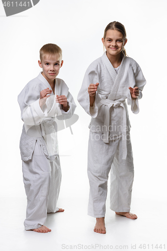 Image of Judo boy and girl students in a rack, white background