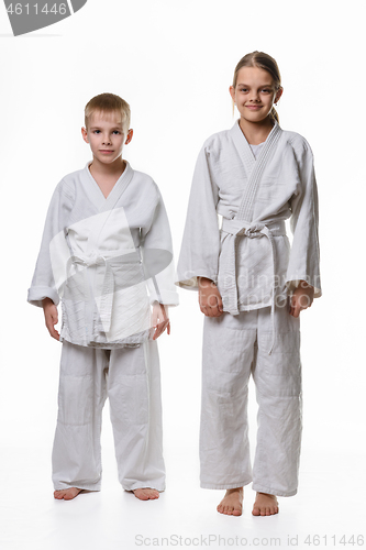 Image of Full-length portrait of a boy and a girl of judo students