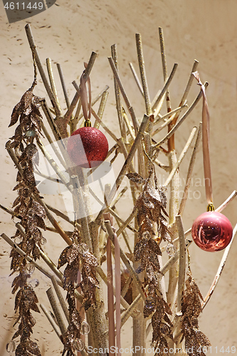 Image of Two red christmas balls on a golden twigs as decoration