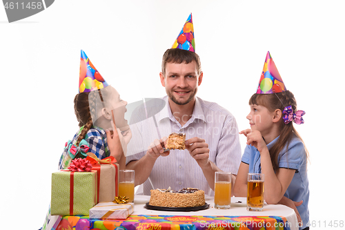 Image of Children ask dad for a piece of holiday cake