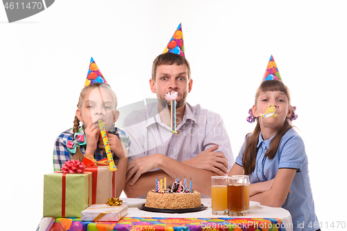 Image of Kids at birthday party have fun blowing whistles