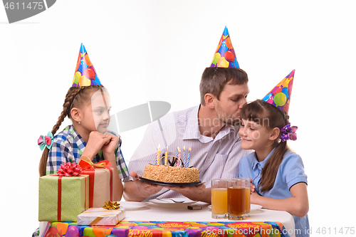 Image of Dad congratulates daughter on his birthday and kisses her