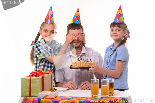 Image of Two sisters prepared a surprise for dad and closed his eyes