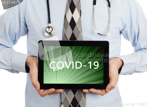 Image of Doctor holding tablet