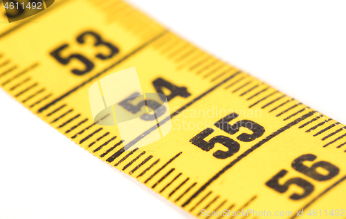 Image of Close-up of a yellow measuring tape isolated on white - 55