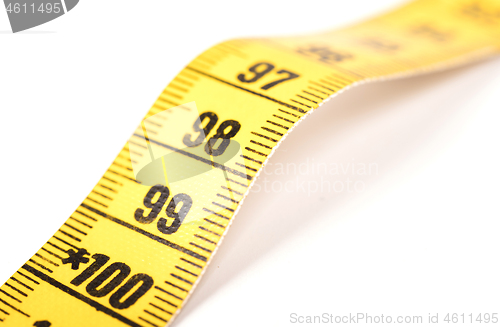 Image of Close-up of a yellow measuring tape isolated on white - 99