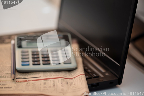 Image of Black notebook, calculator and finance newspaper. Coronavirus concept. Work from home concept