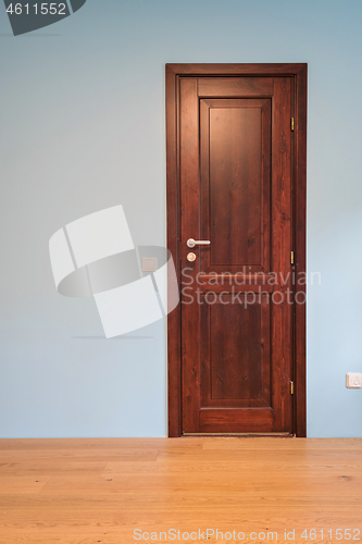 Image of Frontal view to the wooden door in home interior