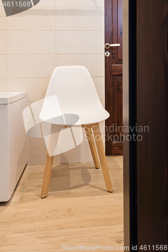 Image of Bathroom interior with bath and stool