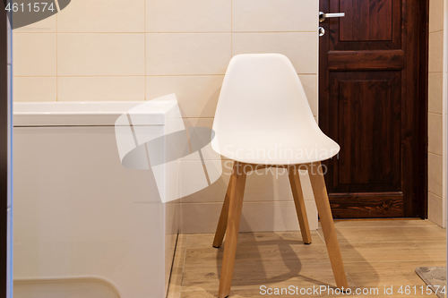 Image of Bathroom interior with bath and stool