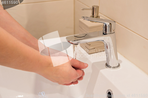 Image of Washing of hands with soap under running water