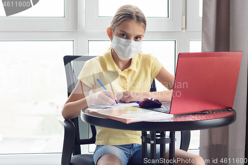 Image of A sick quarantined girl remotely learns and looked in frame